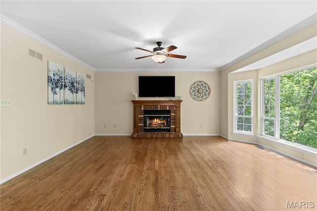16112 Ridgewoods Manor Cir, Ellisville, MO 63038 - unfurnished living room with a ceiling fan, crown molding, wood finished floors, baseboards, and a brick fireplace