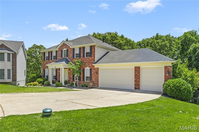 16112 Ridgewoods Manor Cir, Ellisville, MO 63038 - colonial house with concrete driveway, an attached garage, brick siding, and a front lawn