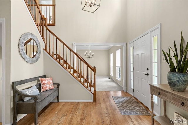 16112 Ridgewoods Manor Cir, Ellisville, MO 63038 - foyer entrance with stairs, a chandelier, a high ceiling, and wood finished floors