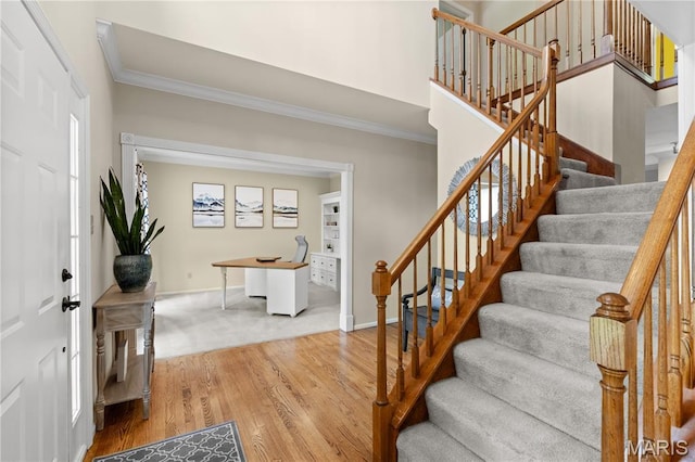 16112 Ridgewoods Manor Cir, Ellisville, MO 63038 - foyer with crown molding, wood finished floors, stairway, and baseboards
