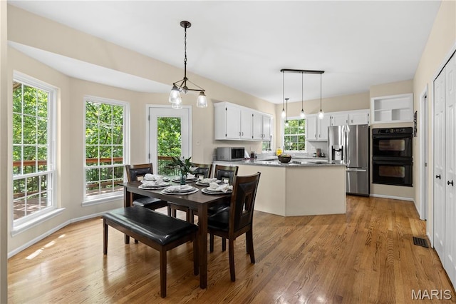 16112 Ridgewoods Manor Cir, Ellisville, MO 63038 - dining area featuring light wood-style floors and baseboards