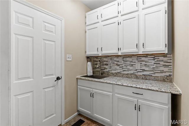16112 Ridgewoods Manor Cir, Ellisville, MO 63038 - kitchen with a sink, backsplash, white cabinetry, and baseboards
