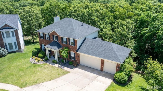 16112 Ridgewoods Manor Cir, Ellisville, MO 63038 - view of front of home featuring brick siding, a chimney, an attached garage, concrete driveway, and a front yard