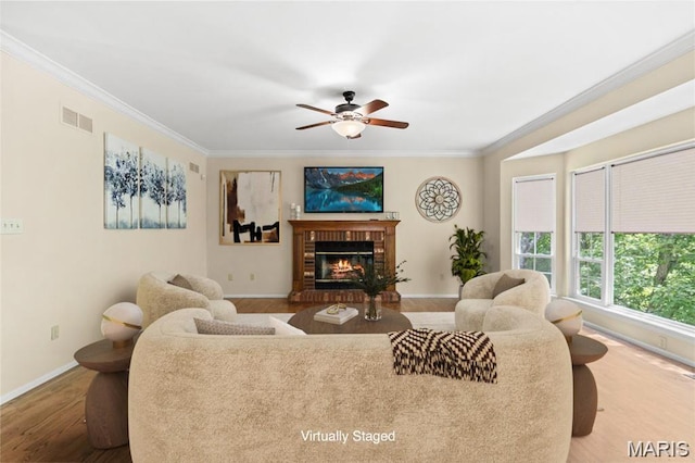 16112 Ridgewoods Manor Cir, Ellisville, MO 63038 - living area featuring wood finished floors, ornamental molding, a ceiling fan, baseboards, and a brick fireplace