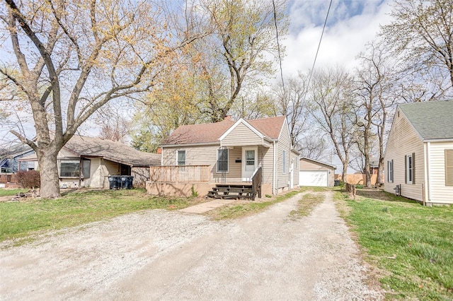 1810 N Van Buren St, Litchfield, IL 62056 - bungalow featuring an outdoor structure, a chimney, a garage, and a front yard