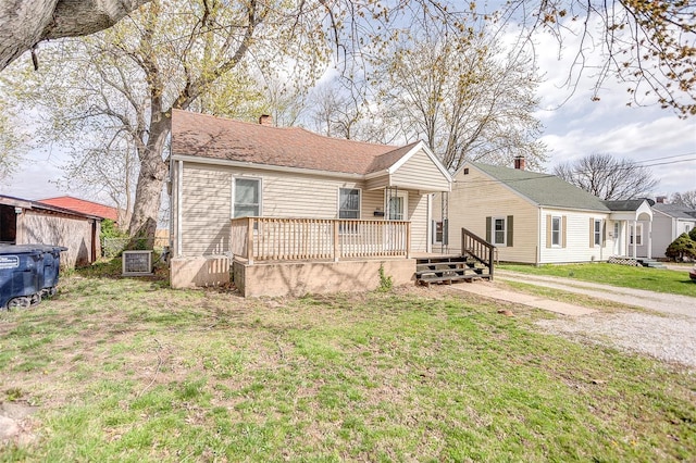 1810 N Van Buren St, Litchfield, IL 62056 - view of front of property featuring a front lawn, a chimney, a wooden deck, and central air condition unit