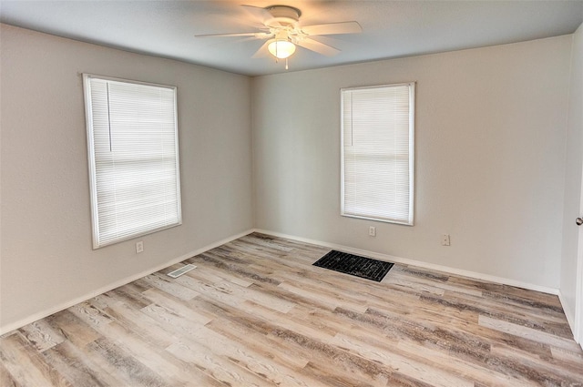 1810 N Van Buren St, Litchfield, IL 62056 - empty room with healthy amount of natural light, ceiling fan, wood finished floors, and baseboards
