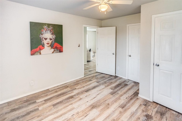 1810 N Van Buren St, Litchfield, IL 62056 - unfurnished bedroom with light wood-style floors, baseboards, and a ceiling fan