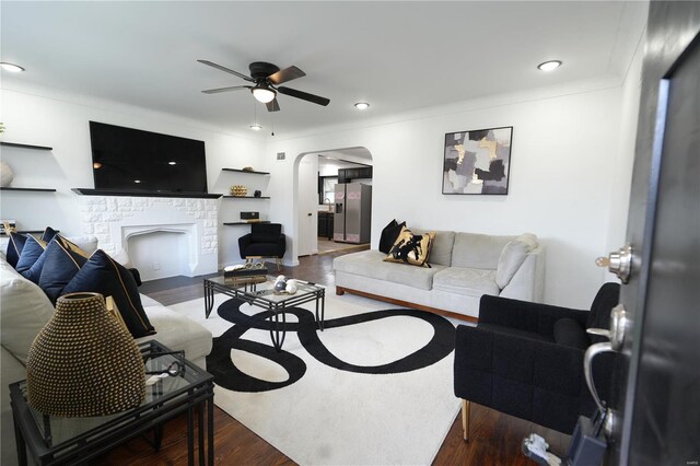 9235 Catalina Dr, Saint Louis, MO 63136 - living area with arched walkways, wood finished floors, ceiling fan, recessed lighting, and a fireplace