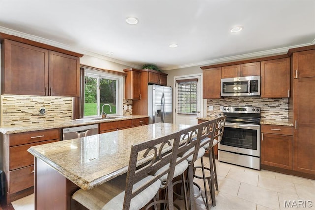269 Braeshire Dr, Ballwin, MO 63021 - kitchen featuring appliances with stainless steel finishes, a sink, plenty of natural light, tasteful backsplash, and crown molding