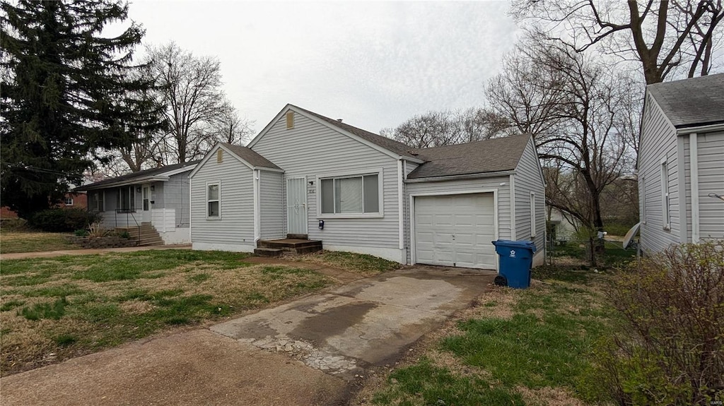 6349 Garfield Ave, Saint Louis, MO 63134 - view of front facade featuring a garage, concrete driveway, and a shingled roof