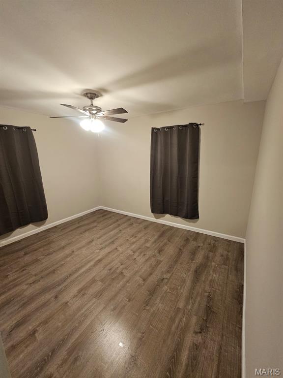 7200 Sapphire Ave, Saint Louis, MO 63136 - unfurnished room featuring dark wood-style flooring and ceiling fan