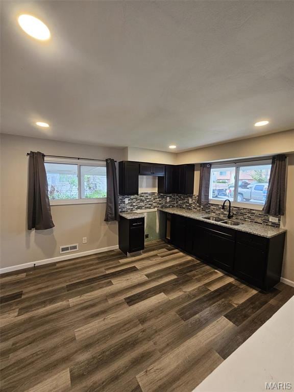 9827 Winkler Dr, Saint Louis, MO 63136 - kitchen featuring a sink, dark cabinets, dark wood-style flooring, recessed lighting, and light stone countertops