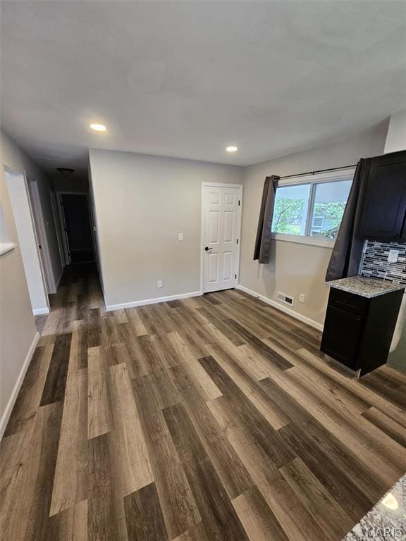9827 Winkler Dr, Saint Louis, MO 63136 - unfurnished living room with dark wood-style flooring, baseboards, and recessed lighting