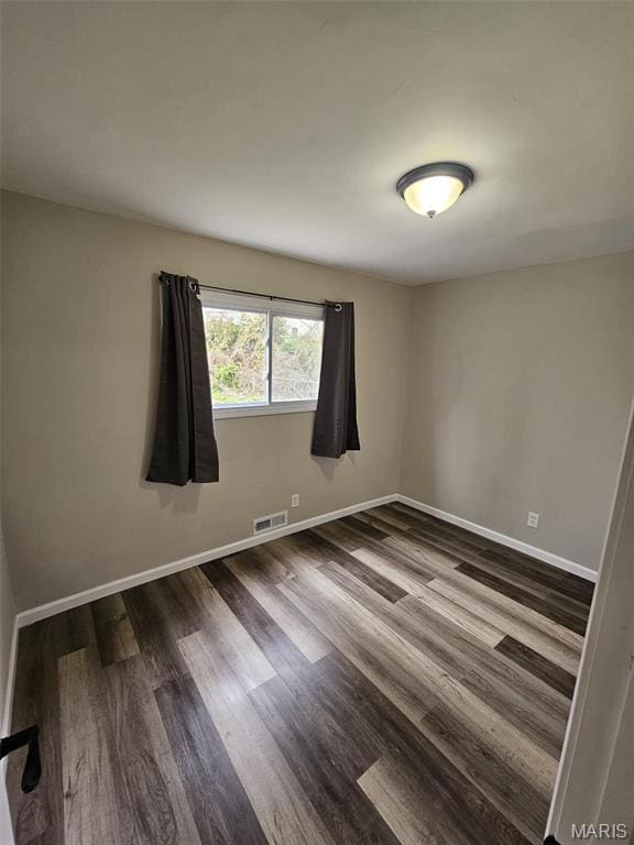 9827 Winkler Dr, Saint Louis, MO 63136 - unfurnished room with dark wood finished floors and baseboards
