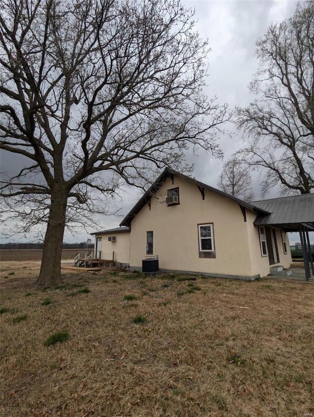 42661 State Highway Mm, Malden, MO 63863 - view of property exterior with stucco siding, a lawn, and metal roof
