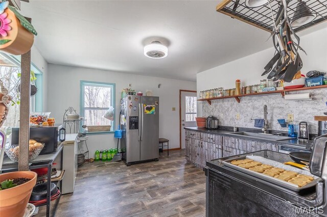345 Johns Branch Rd, Wappapello, MO 63966 - kitchen featuring stainless steel fridge, a sink, wood finished floors, tasteful backsplash, and dark countertops