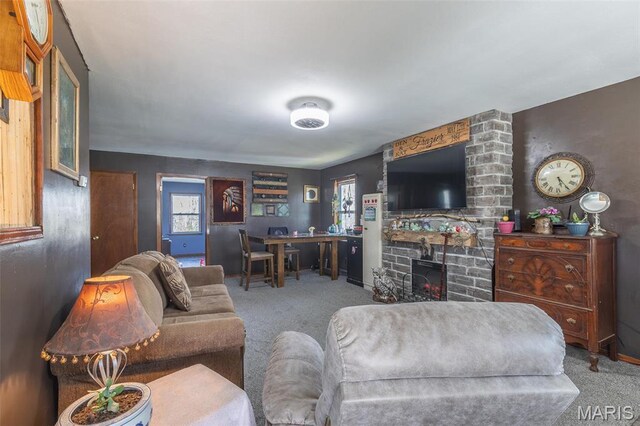 345 Johns Branch Rd, Wappapello, MO 63966 - living room featuring carpet flooring, a stone fireplace, and baseboards