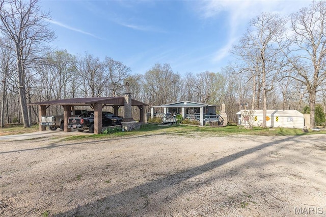 345 Johns Branch Rd, Wappapello, MO 63966 - view of front facade with driveway, a carport, and an outdoor structure