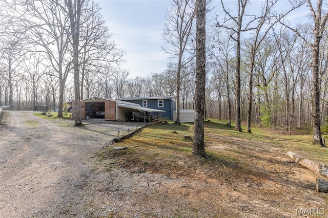 345 Johns Branch Rd, Wappapello, MO 63966 - mid-century home featuring driveway, an attached carport, and an outdoor structure
