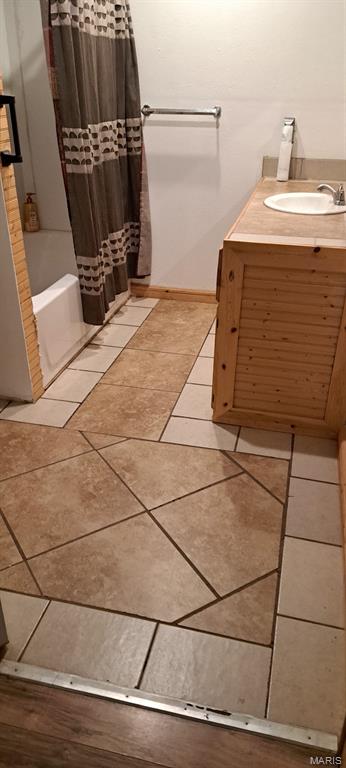 345 Johns Branch Rd, Wappapello, MO 63966 - full bathroom with vanity, shower / bath combo, tile patterned floors, and baseboards