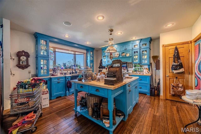 20955 Rye Ln, Richland, MO 65556 - kitchen with blue cabinets, wooden counters, dark wood-style floors, and recessed lighting