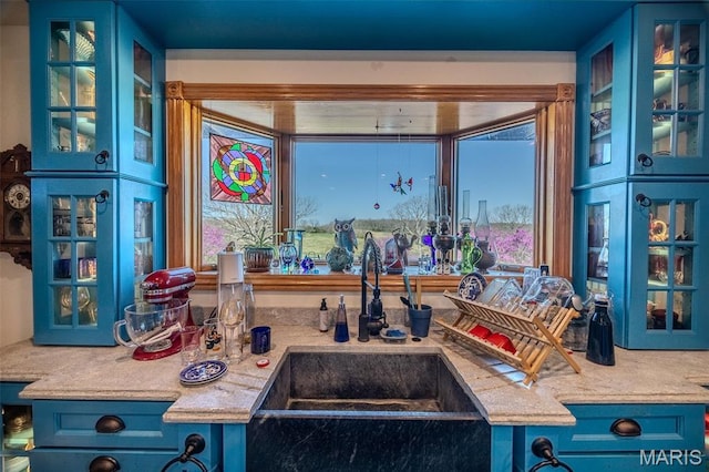 20955 Rye Ln, Richland, MO 65556 - kitchen featuring blue cabinets, glass insert cabinets, and light countertops