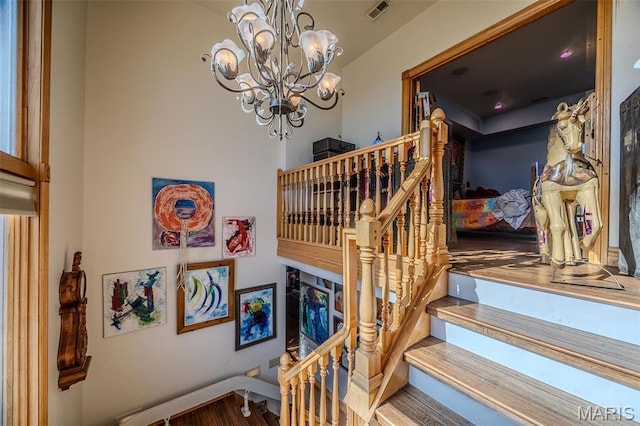 20955 Rye Ln, Richland, MO 65556 - staircase featuring wood finished floors and a chandelier