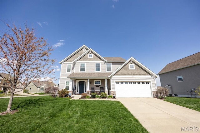 craftsman-style house with covered porch, a garage, driveway, stone siding, and a front lawn