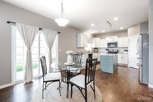 dining space featuring plenty of natural light, dark wood-type flooring, baseboards, and recessed lighting