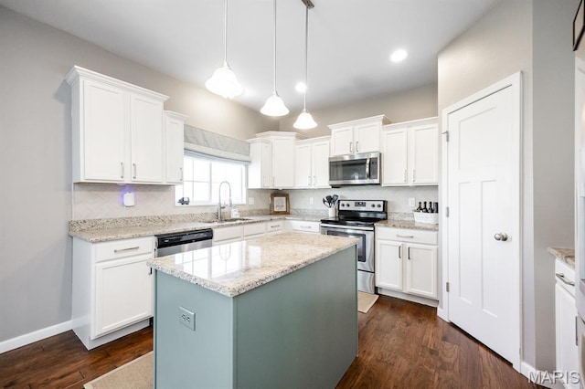 kitchen with appliances with stainless steel finishes, a sink, white cabinetry, and recessed lighting