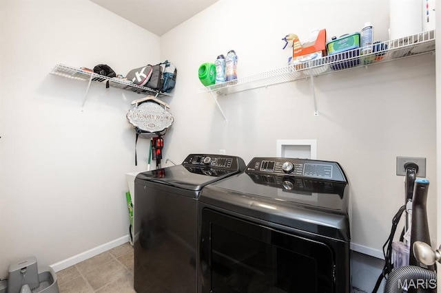 laundry room featuring washing machine and clothes dryer and baseboards