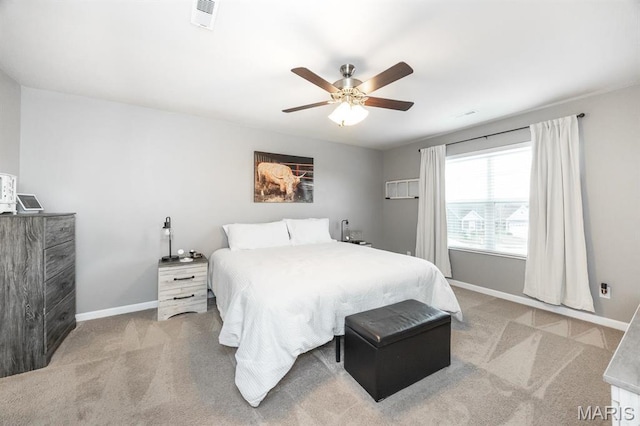 carpeted bedroom with baseboards and a ceiling fan