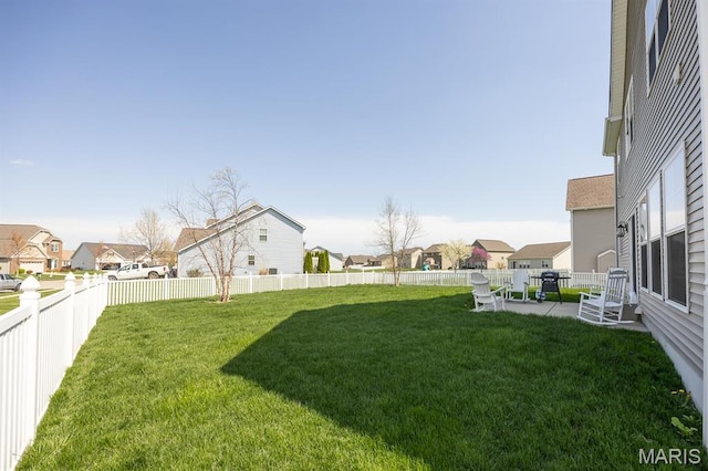 view of yard featuring a residential view and a patio