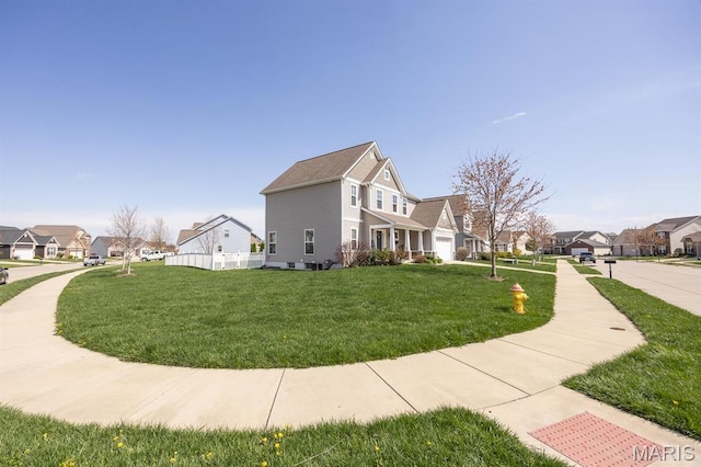 view of side of home featuring a residential view and a lawn