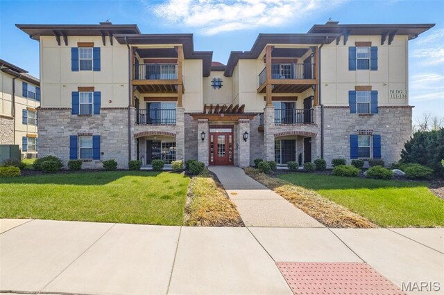 121 Bordeaux Way, Saint Peters, MO 63376 - view of property featuring stone siding, stucco siding, and a front lawn