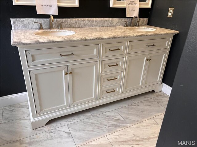 202 Reliance Rd, Foristell, MO 63385 - full bathroom featuring marble look tile flooring, double vanity, and baseboards