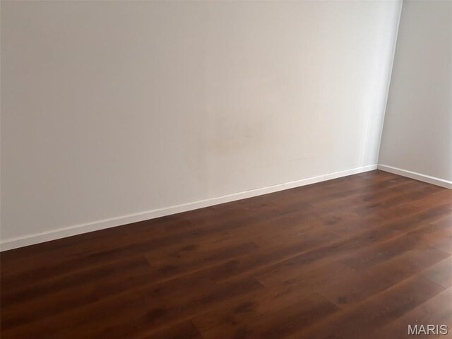 202 Reliance Rd, Foristell, MO 63385 - empty room with dark wood-style flooring and baseboards