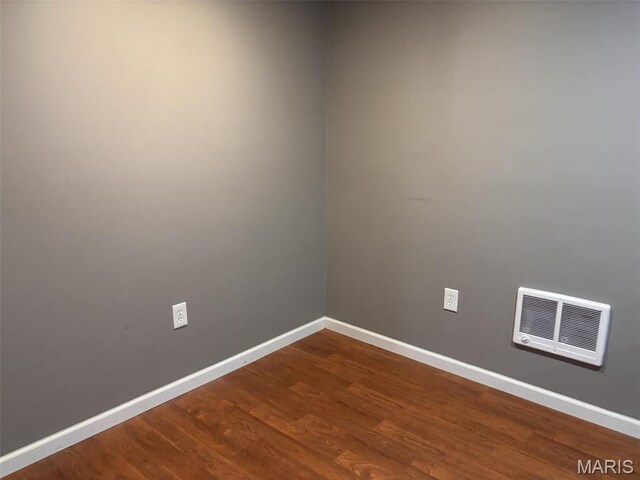 202 Reliance Rd, Foristell, MO 63385 - spare room featuring baseboards and dark wood-style flooring
