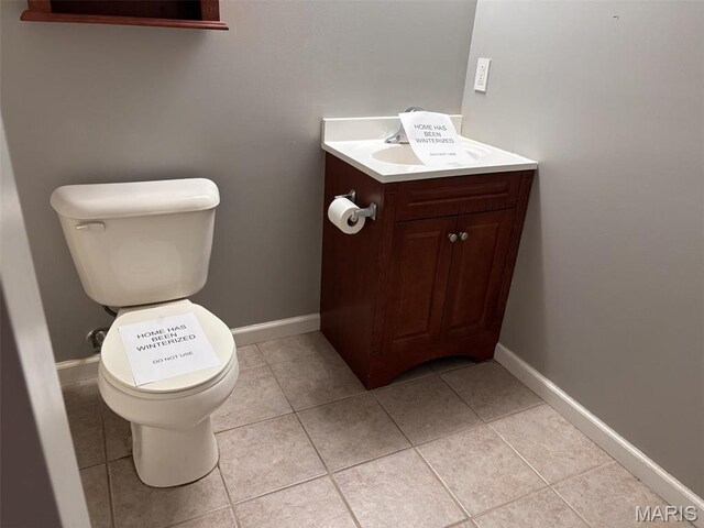 202 Reliance Rd, Foristell, MO 63385 - half bathroom featuring toilet, vanity, tile patterned floors, and baseboards