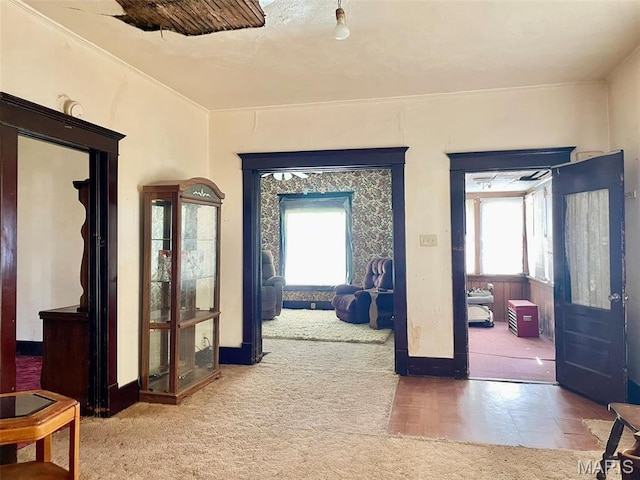 hall featuring carpet floors and baseboards