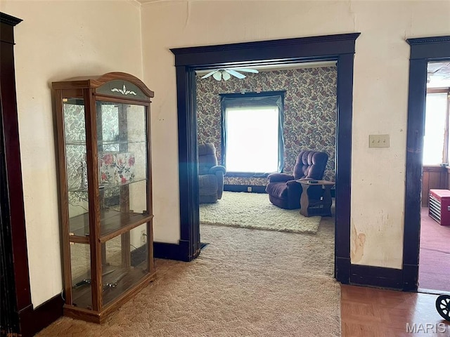 hallway with healthy amount of natural light and baseboards