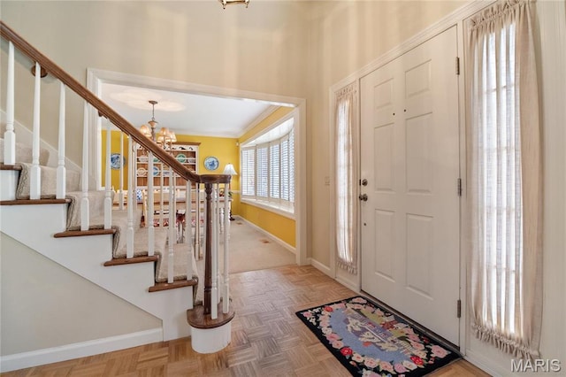 405 Seven Gables Ct, Chesterfield, MO 63017 - entrance foyer featuring a chandelier, stairs, baseboards, and ornamental molding