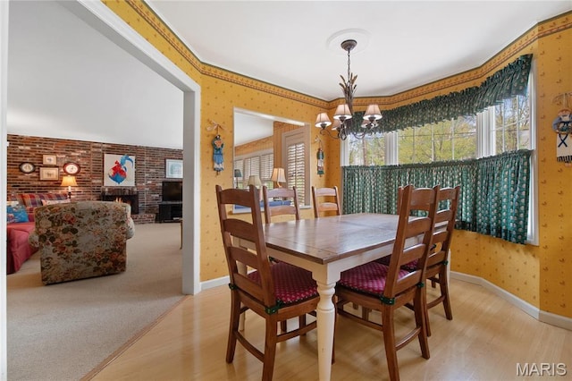 405 Seven Gables Ct, Chesterfield, MO 63017 - dining area with light wood finished floors, wallpapered walls, a chandelier, plenty of natural light, and baseboards