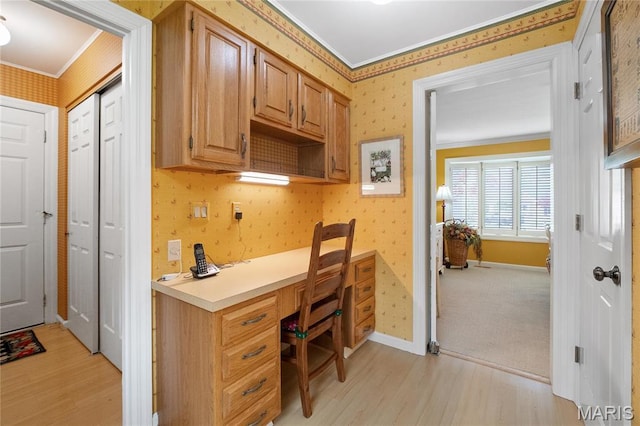 405 Seven Gables Ct, Chesterfield, MO 63017 - office area with ornamental molding, wallpapered walls, light wood-style flooring, built in desk, and baseboards