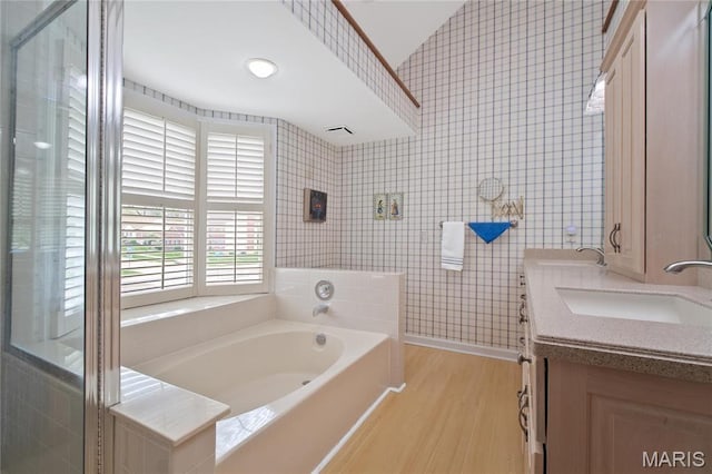 405 Seven Gables Ct, Chesterfield, MO 63017 - full bathroom featuring wood finished floors, wallpapered walls, a bath, double vanity, and baseboards