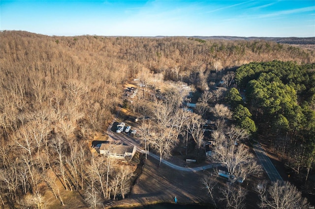 aerial view of property's location featuring a forest