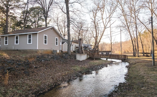 view of property exterior featuring a wooden deck and crawl space