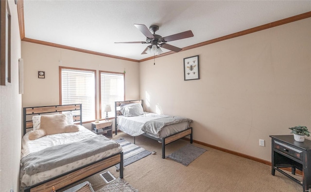 bedroom with crown molding, carpet, baseboards, and ceiling fan