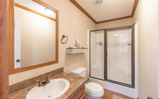 full bathroom with a shower with shower door, ornamental molding, toilet, and vanity